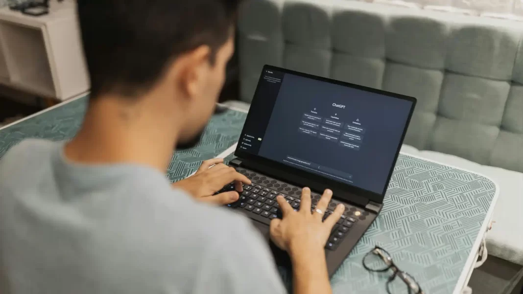 Developer using ChatGPT AI tool on laptop